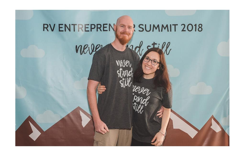 Brooke and Buddy in front of the sign at RV Entrepreneur Summit