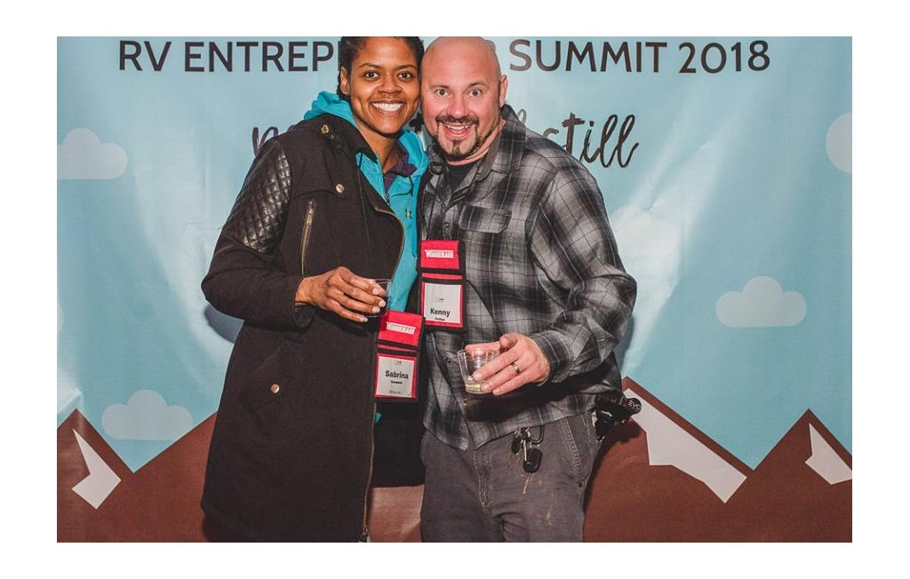 Sabrina and Kenny in front of sign at RVE Summit