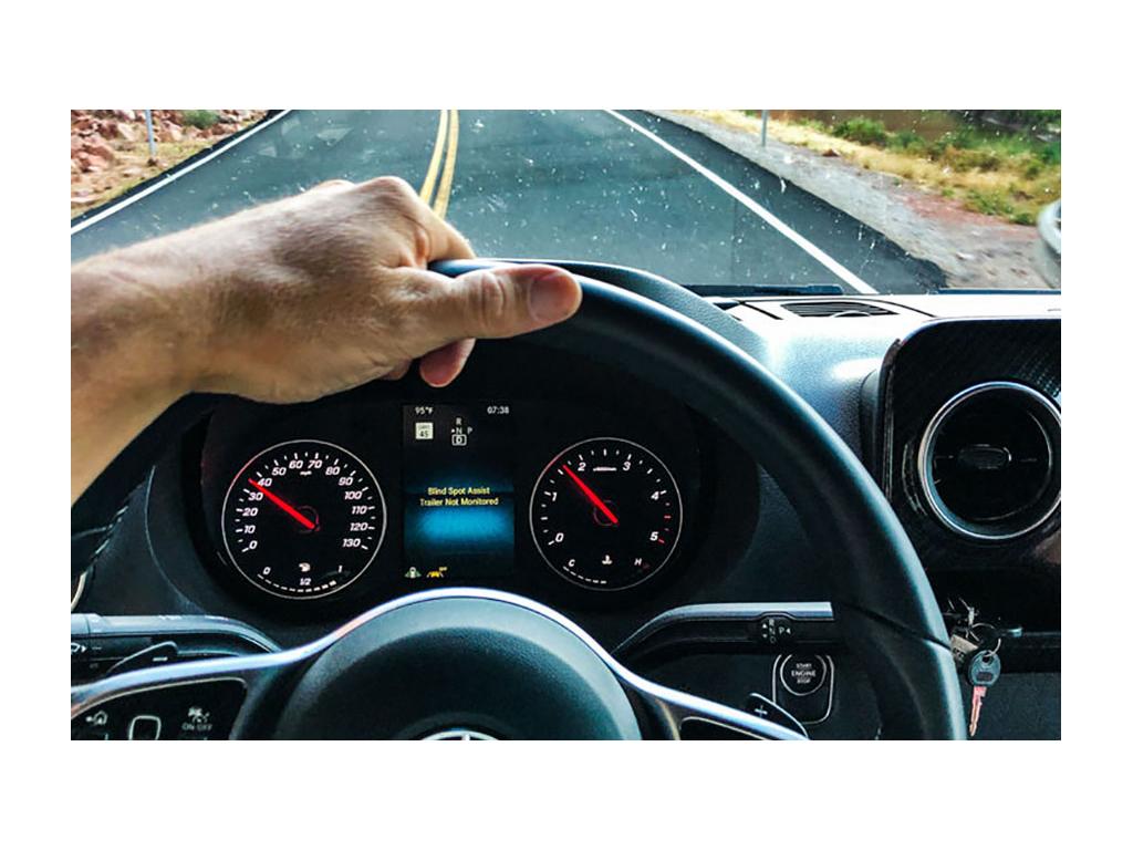 View through windshield of Revel while driving down road.