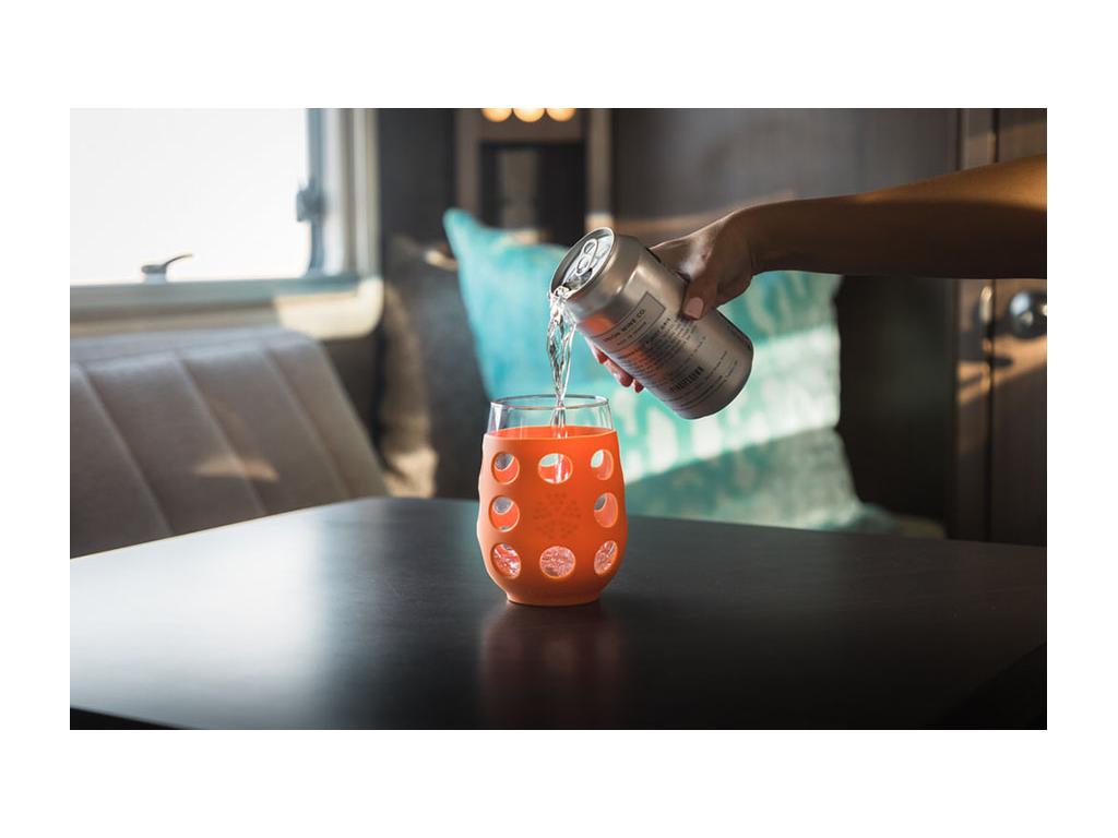 Nadia pouring can of wine into glass