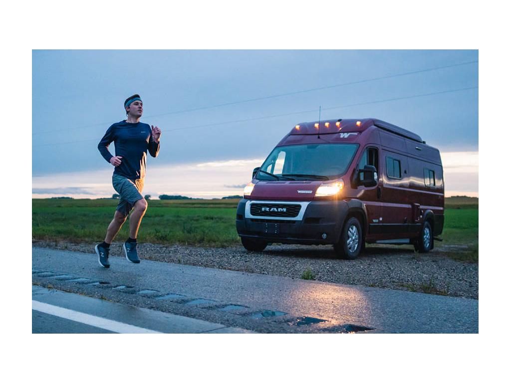 Mikah running on road with Solis parked with lights on