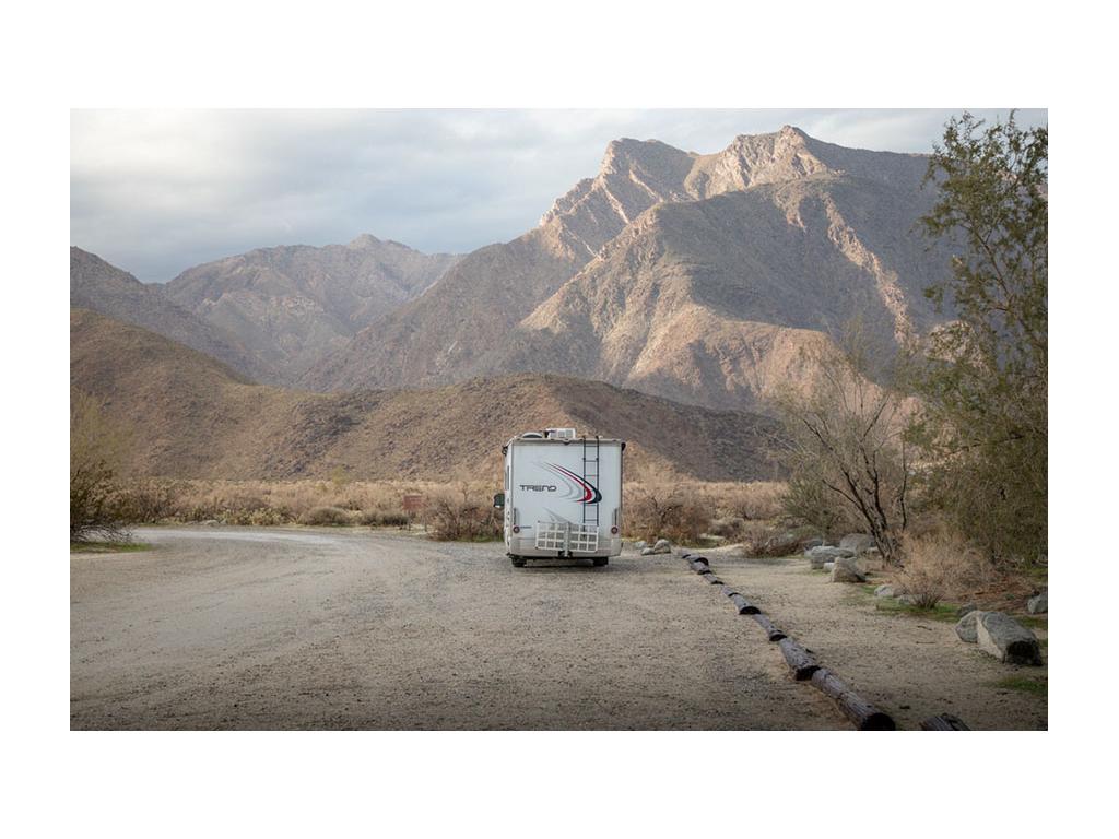 Back of the Trend parked next to mountains in California