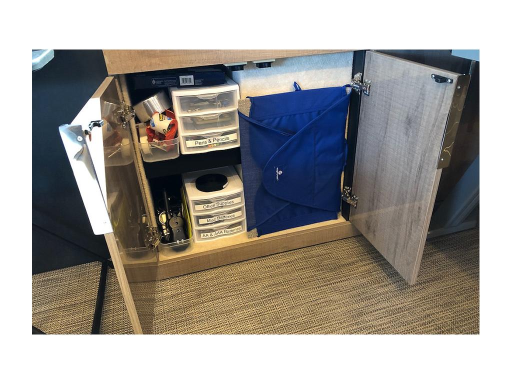 Plastic bins with white labels on them