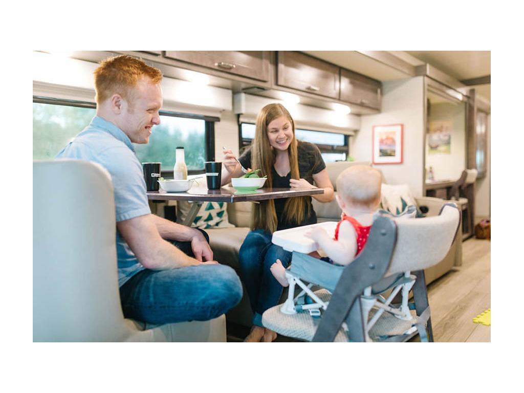 Alyssa, Heath and Ellie eating at dinette. Ellie is sitting in a high chair