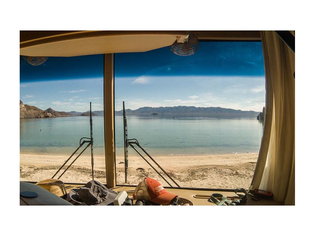 View of beach and water out of windshield of Journey