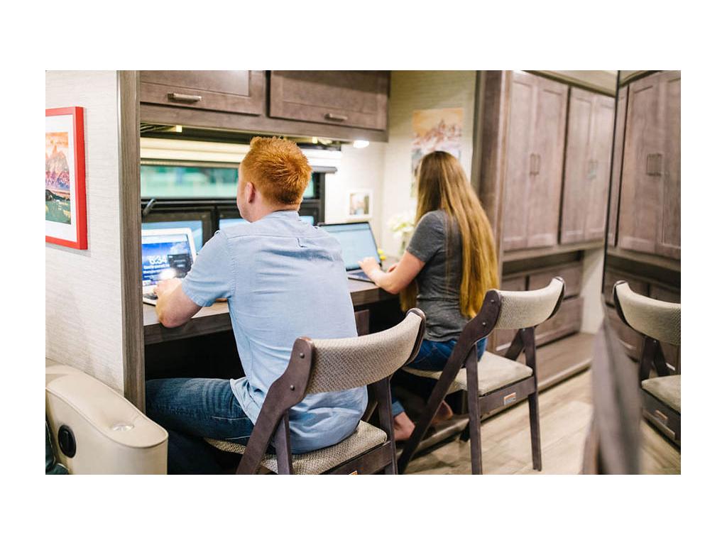 Heath and Alyssa working on laptops at hobby desk