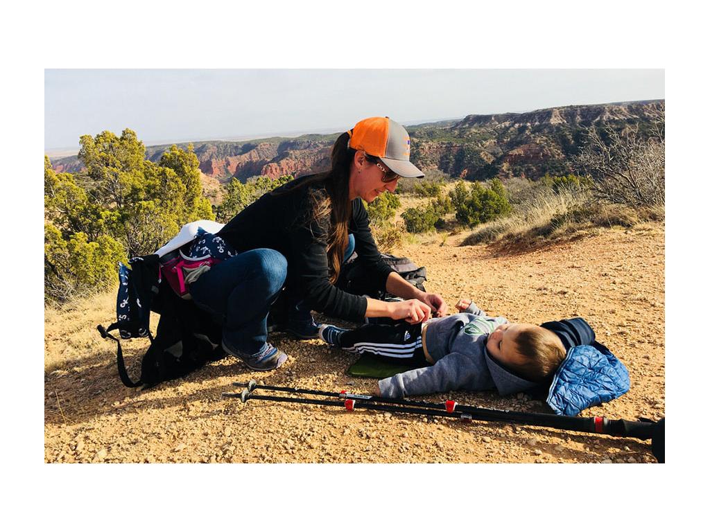 Brittany changing Caspian while hiking
