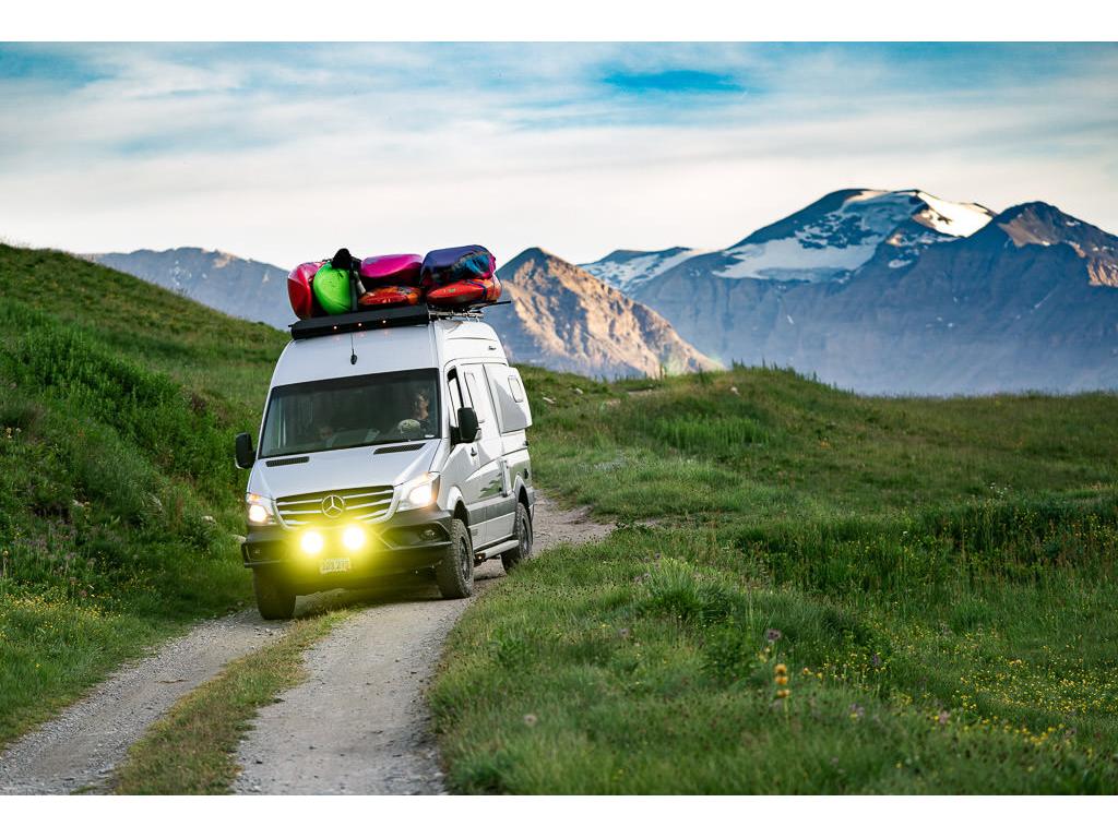 Winnebago Revel being driven on dirt road through the Swiss Alps