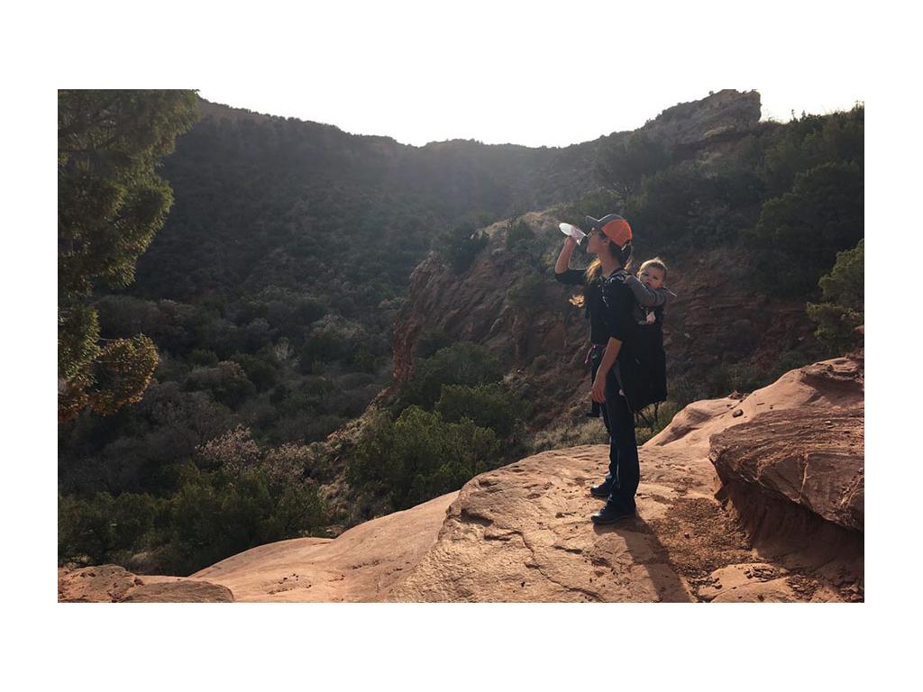 Brittany hiking with Caspian in kid's backpack