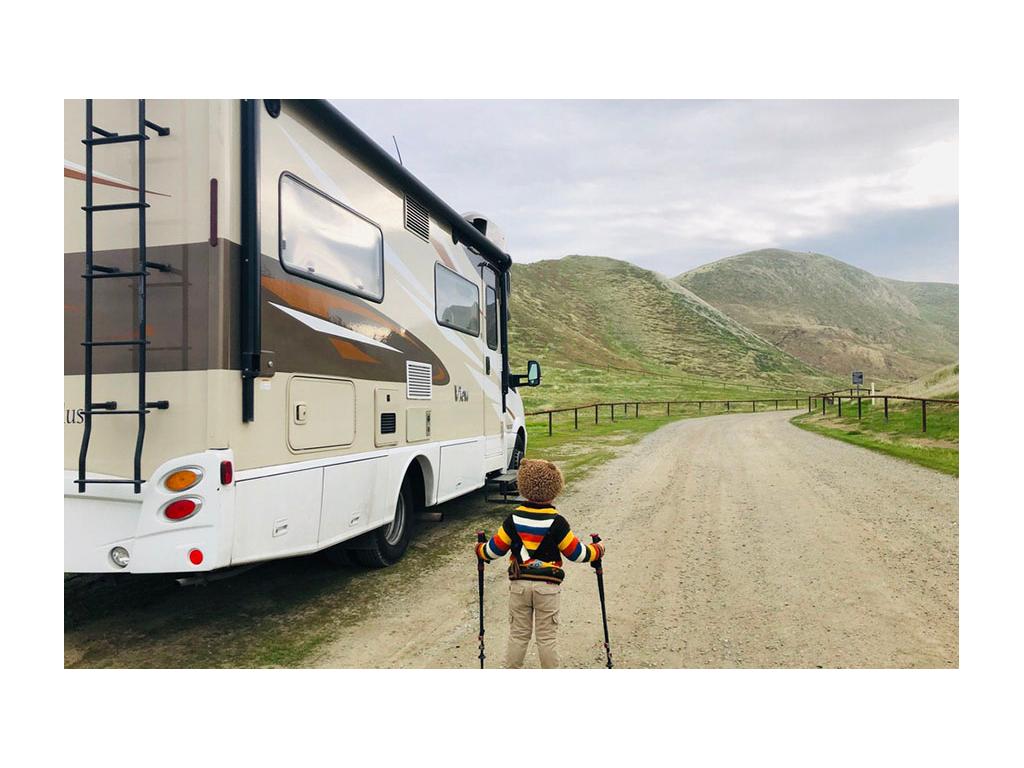 Caspian with hiking sticks standing next to Via