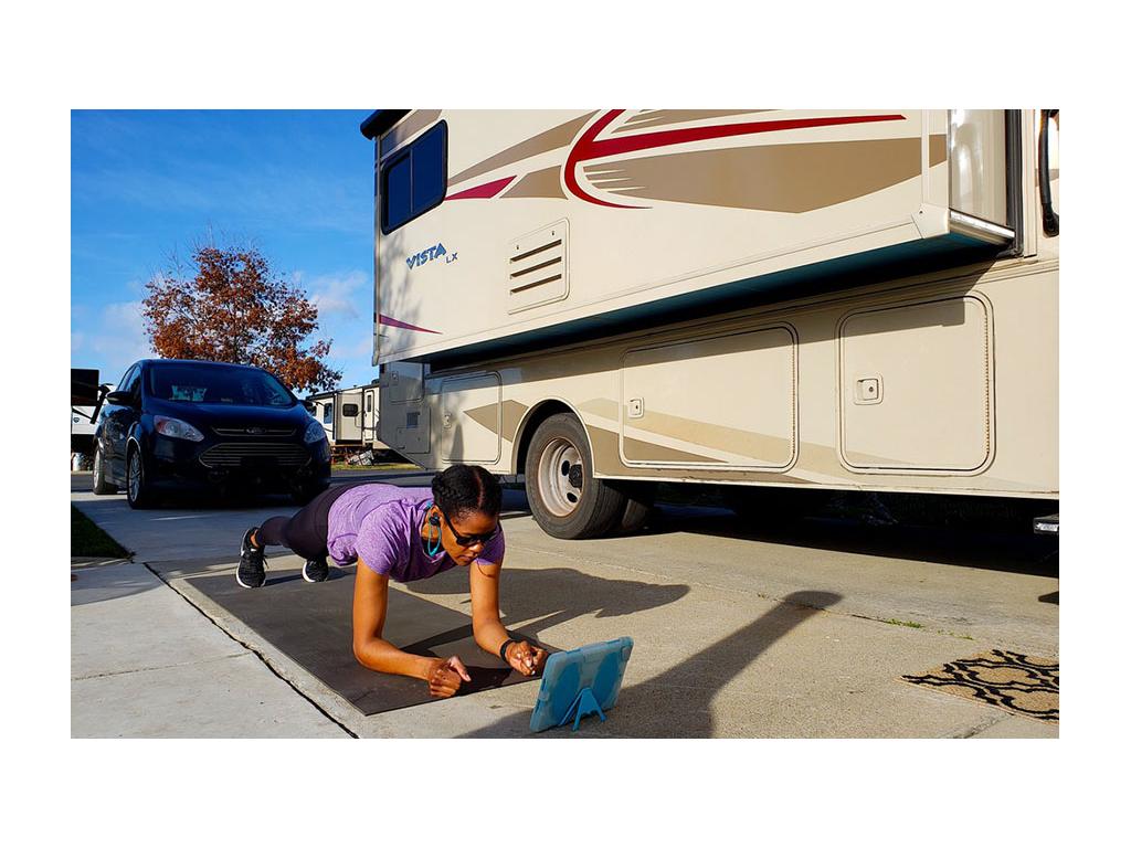 Sabrina doing a plank on yoga mat next to the Vista