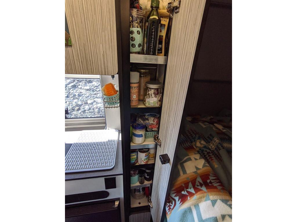 Pantry with three shelves full of food