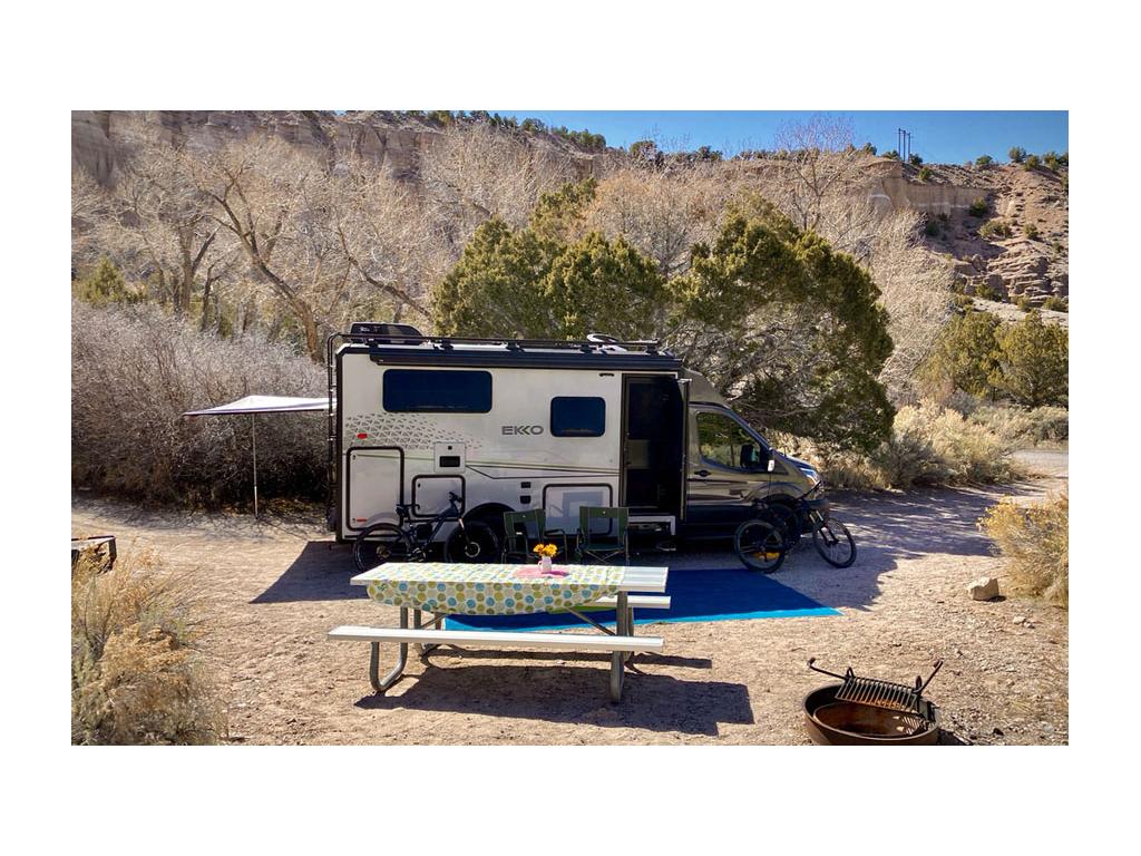 Winnebago EKKO parked in desert next to picnic table