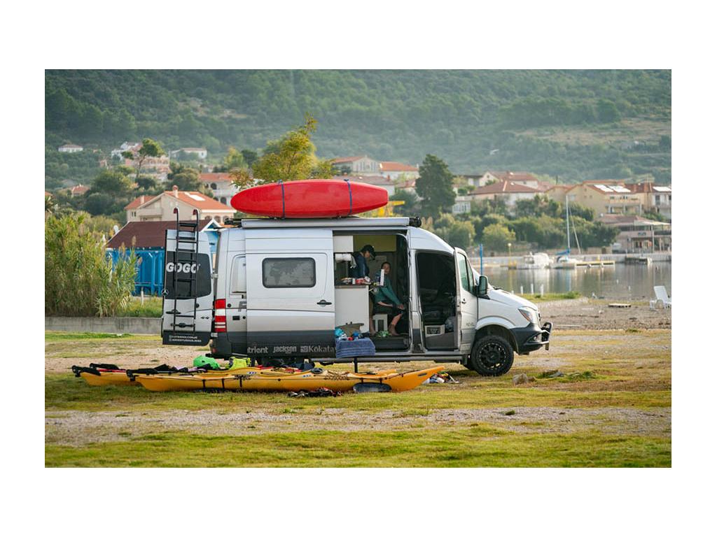 Abby and Kathy sitting in Revel with kayaks outside preparing for kayak trip
