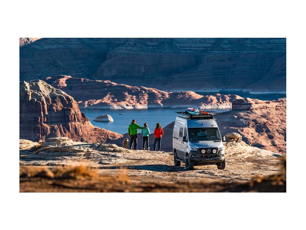 Holcombe family looking over mountain at water with Revel behind them