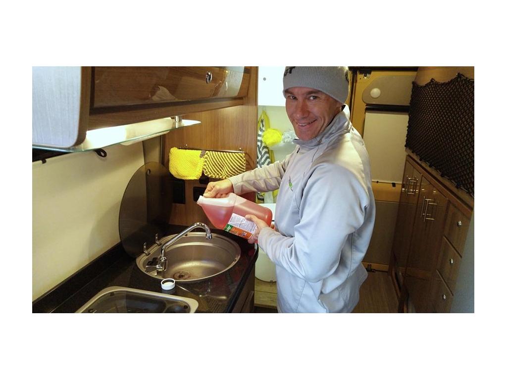 James pouring anti-freeze down sink