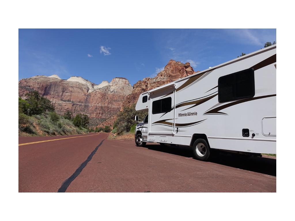 Winnebago Minnie Winnie driving down the road in Zion National Park