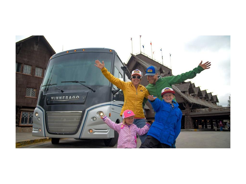 The Pyke family huddled together in front of the Winnebago Adventurer