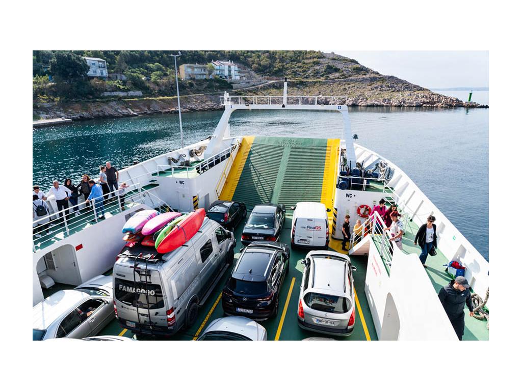 Revel traveling on a ferry with cars around it