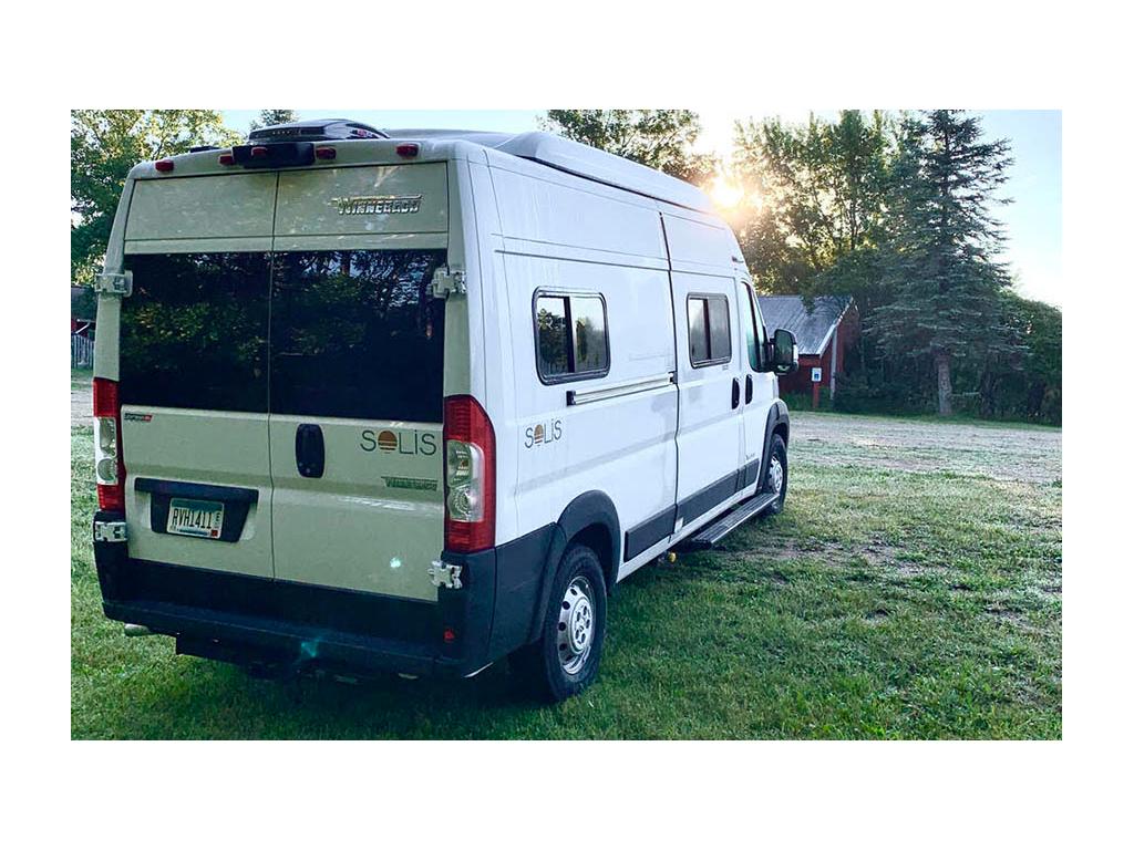 Side shot of Solis from rear with sun peeking out behind trees