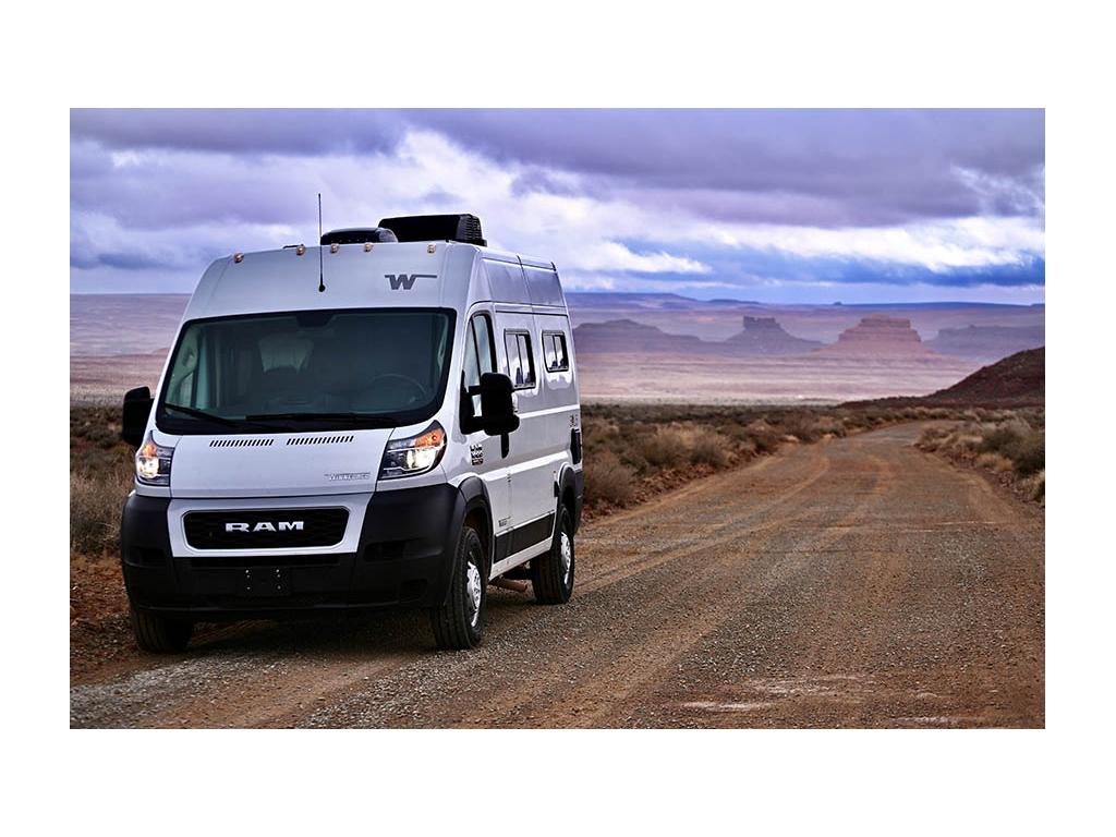 Solis Pocket driving down dirt road during sunset