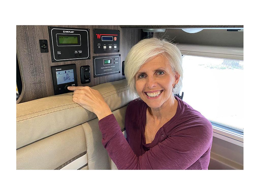 Chris pointing in Truma Combi Eco Plus Heating System in Travato