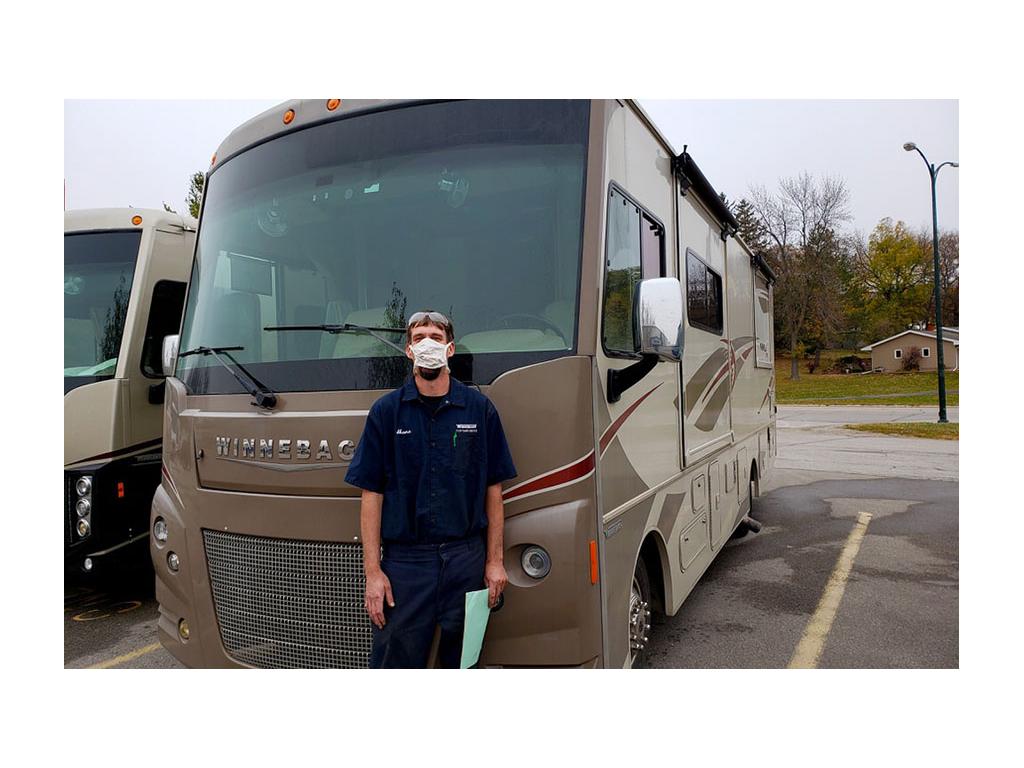 Service tech wearing mask standing in front of Vista