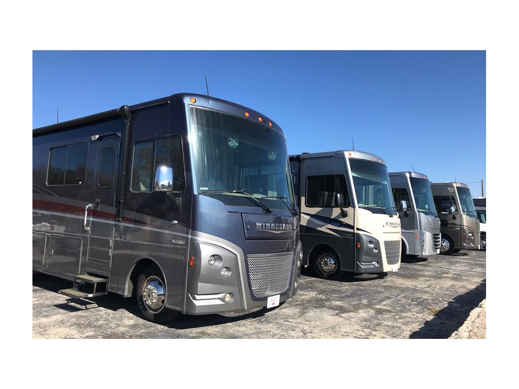 Winnebago Class A motorhomes lined up on dealer lot