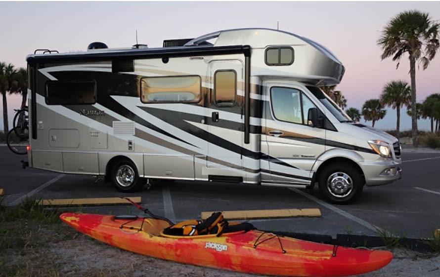Winnebago Navion with orange kayak in front of it
