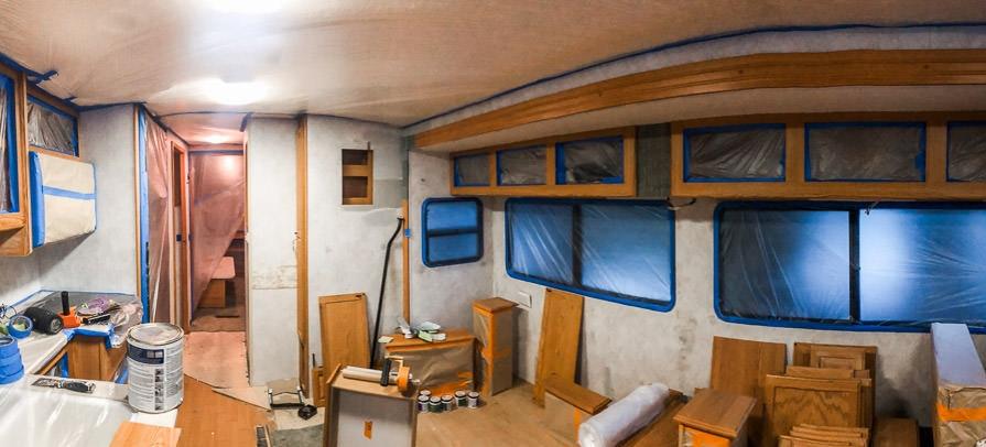 Living room mid-renovation with trim taped off for painting