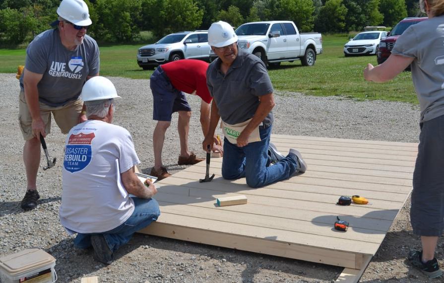 A group of RV Care-A-Vanners building part of the shed