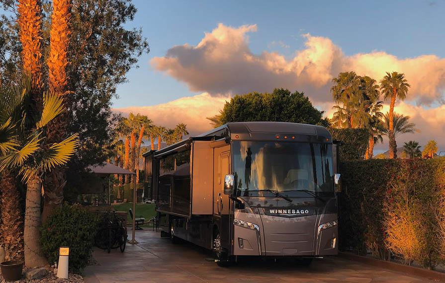 Horizon parked under palm trees with colorful sunset