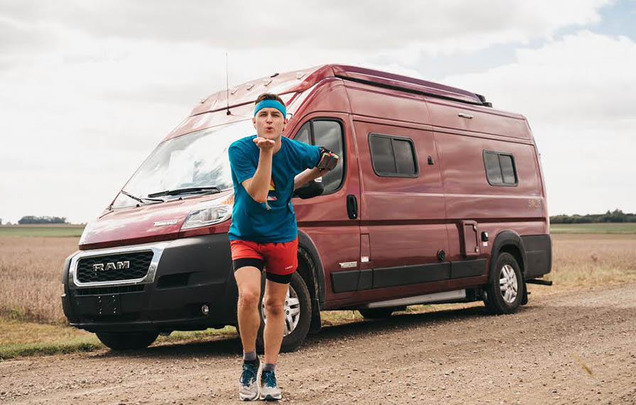 Mikah standing in front of Solis with hand on hip blowing a kiss