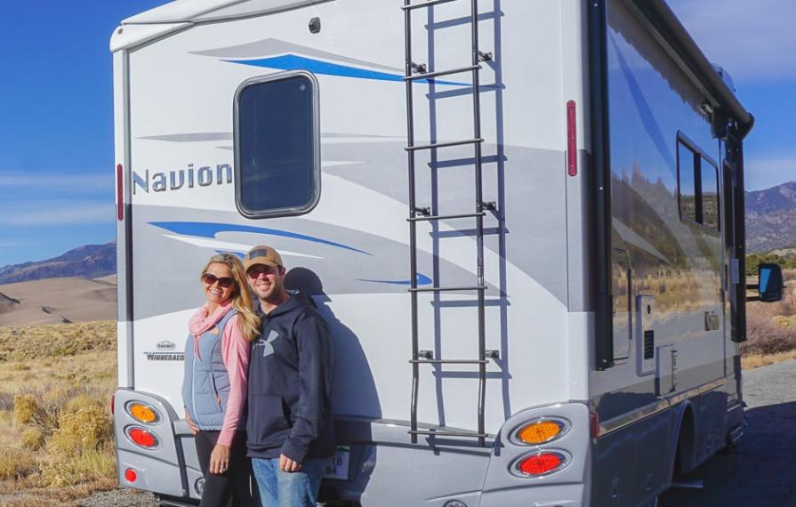 Lindsay and Dan smiling in front of Navion