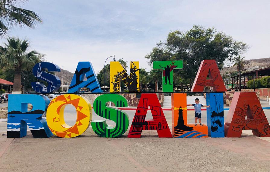 Caspian standing inside of Santa Rosalia sign