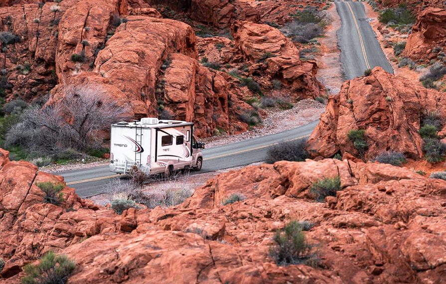 Trend driving through red colored rocks in Valley of Fire