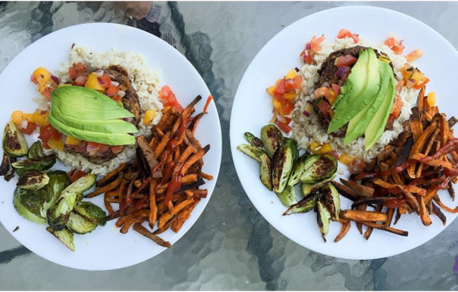 Two plates full of colorful food