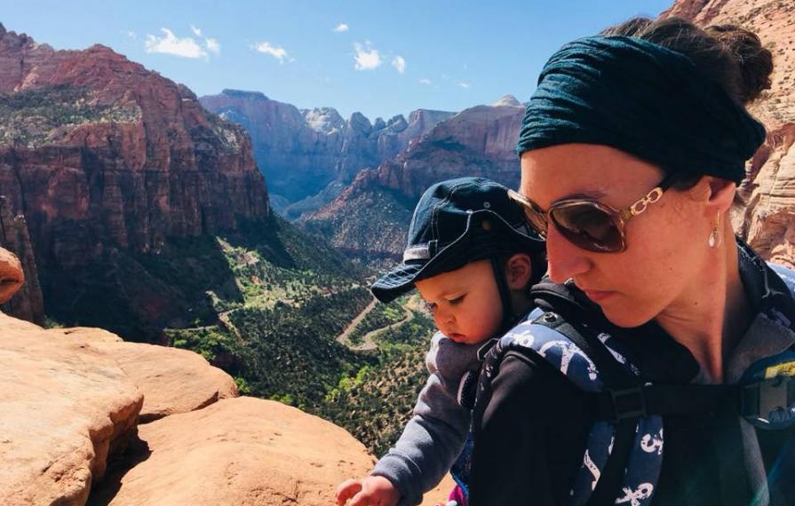 Brittany and Caspian Hiking in Zion National Park. Caspian is on Brittany's back in a pack