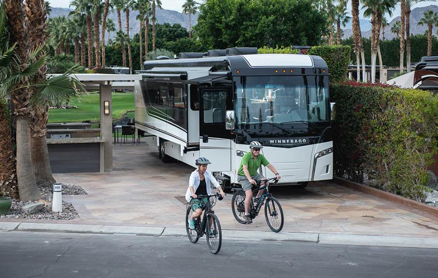 Don and Terry riding bikes with Horizon and palm trees in background