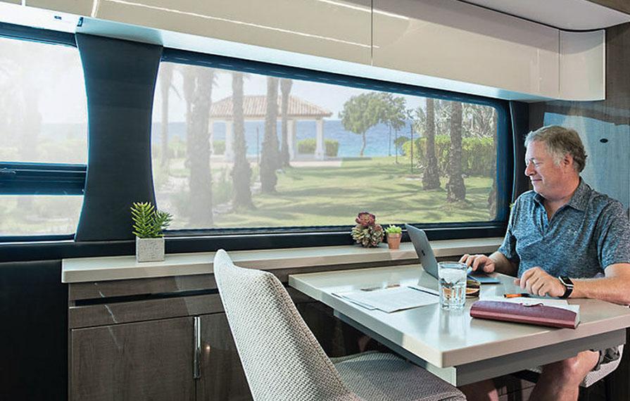 Don working on computer at kitchen table