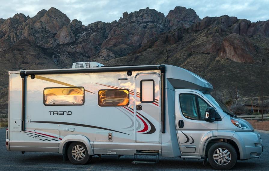 Winnebago Trend full passenger side view, parked in mountainous desert area