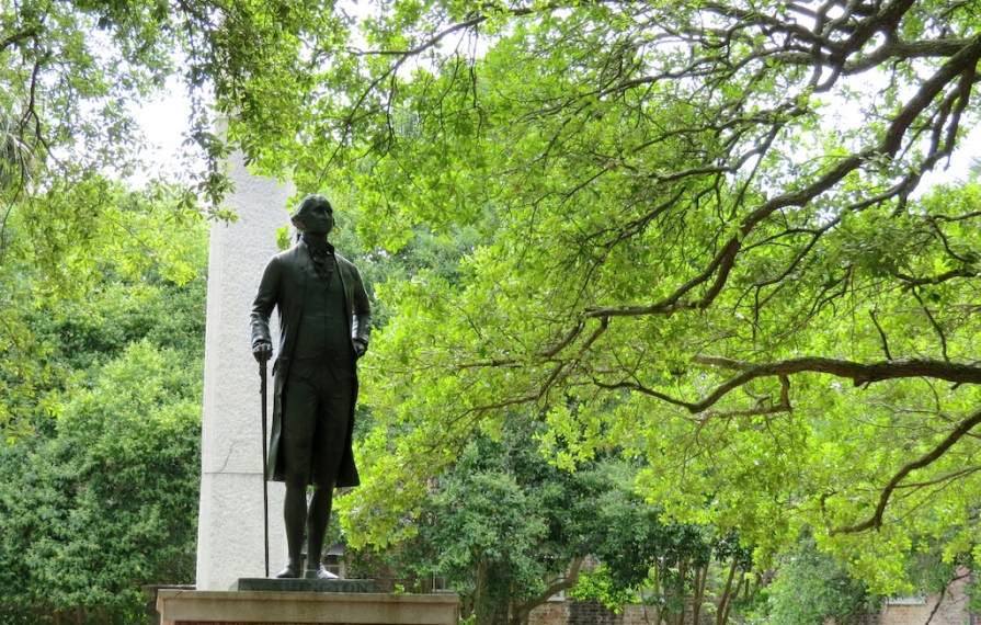 Statue of George Washington among the trees.