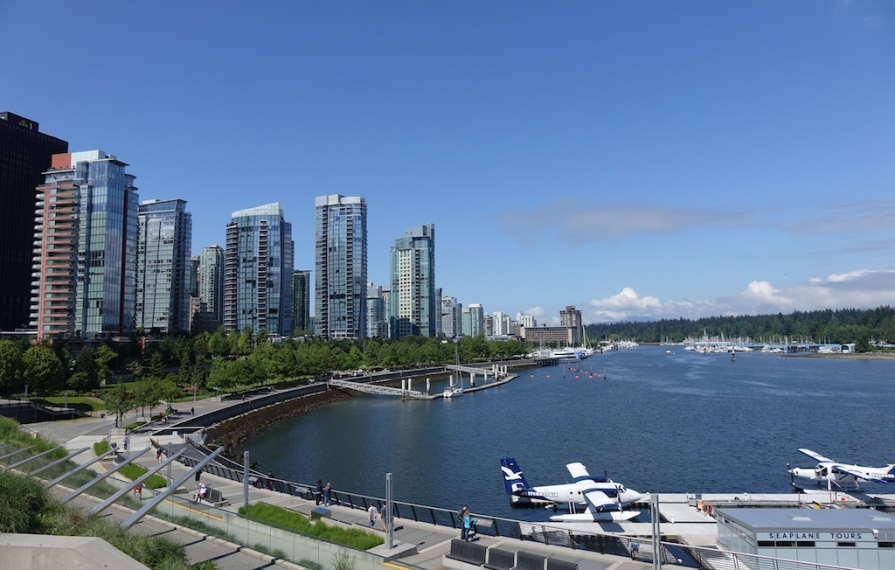 Vancouver Coal Harbor lined with tall buildings along the water.