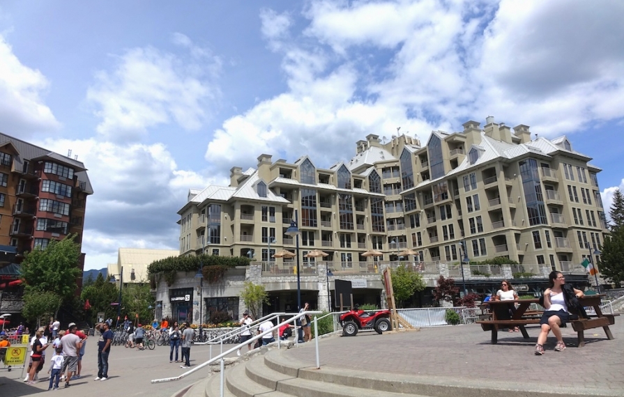 Whistler hotel with people gathered around plaza out front.