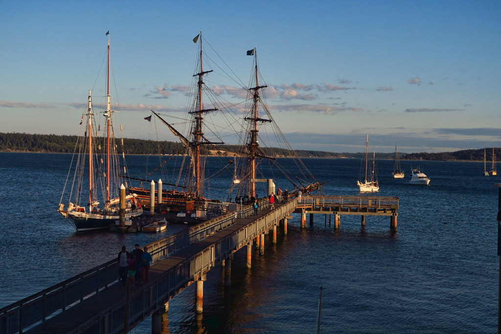 Wooden boats docked at a pier. 