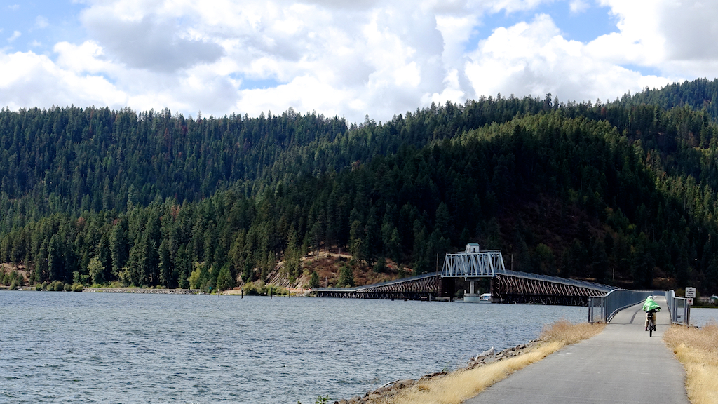 Biker going across Chatcolet Bridge between Lake Coeur d'Alene and Lake Chatcolet.