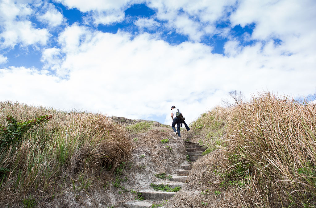 Jordan climbing up a set of steps to hill above.