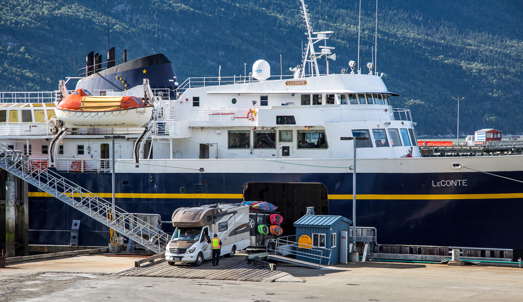 Winnebago View with trailer attached backing into the lower level of the ferry.