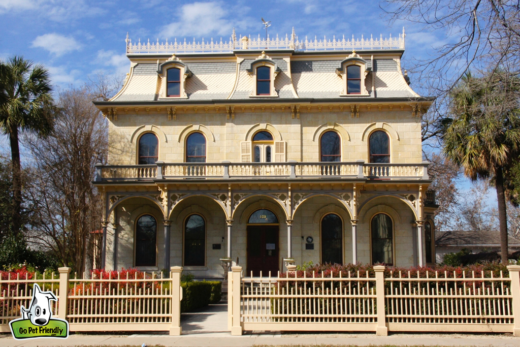 Old brick home with lots of windows.