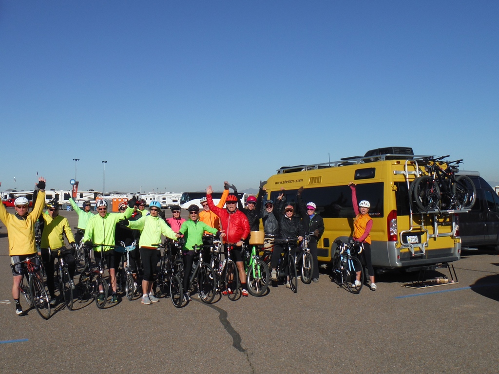 Group of people with their bikes outside Winnebago Travato.